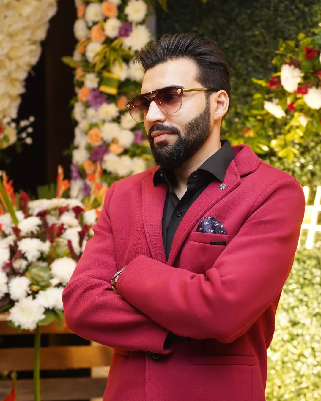 Revaansh Kohli with arms crossed in a red blazer
