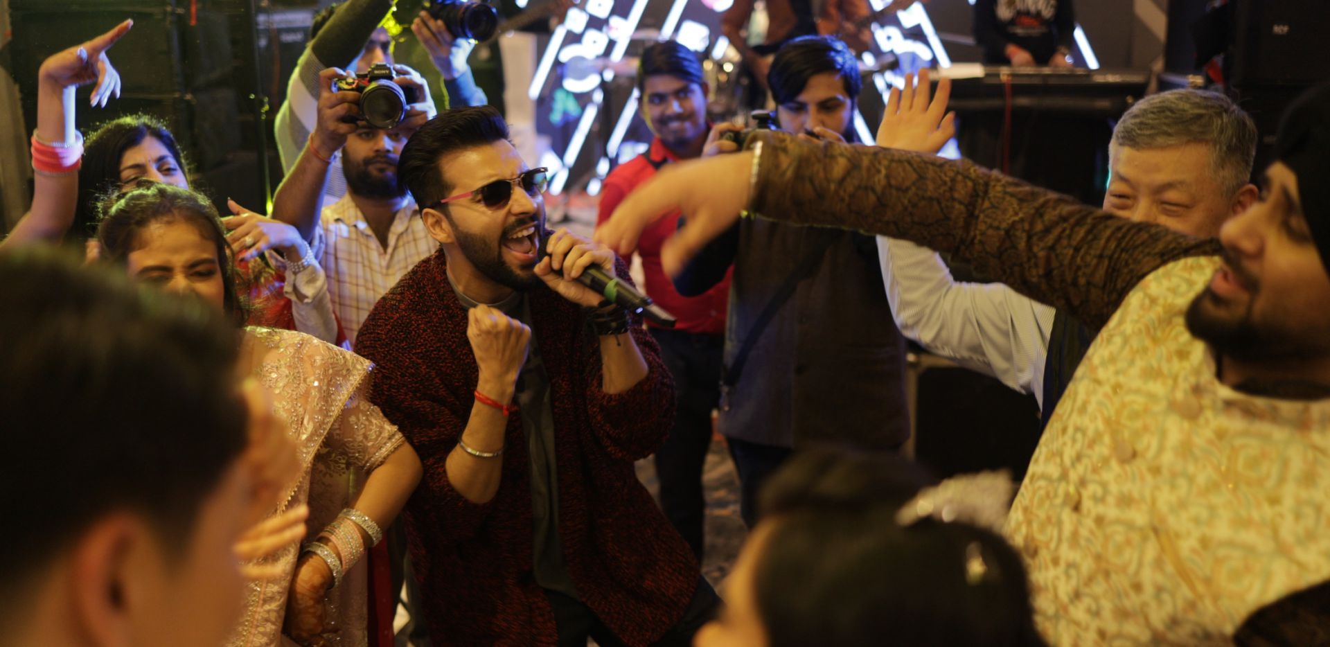 Revaansh Kohli singing among guests on the dance floor